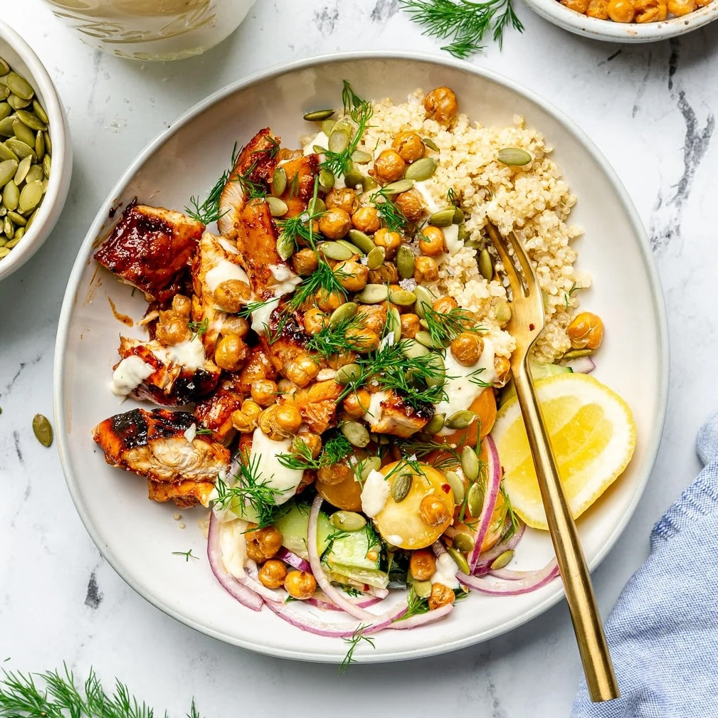 High-Protein Butter Chicken & Crispy Chickpeas Quinoa Bowl with marinated chicken, quinoa, and fresh vegetables.